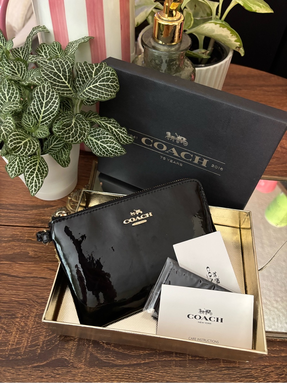 Black and gold COACH wristlet